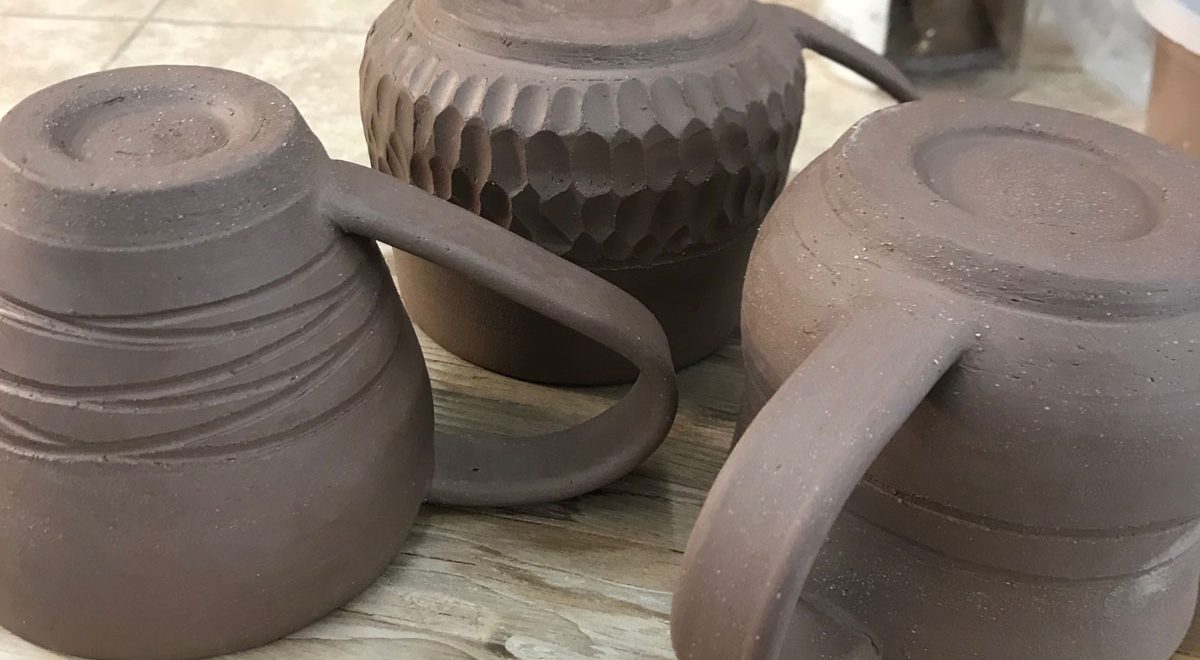 first thrown mugs with handles, trimmed and dryng