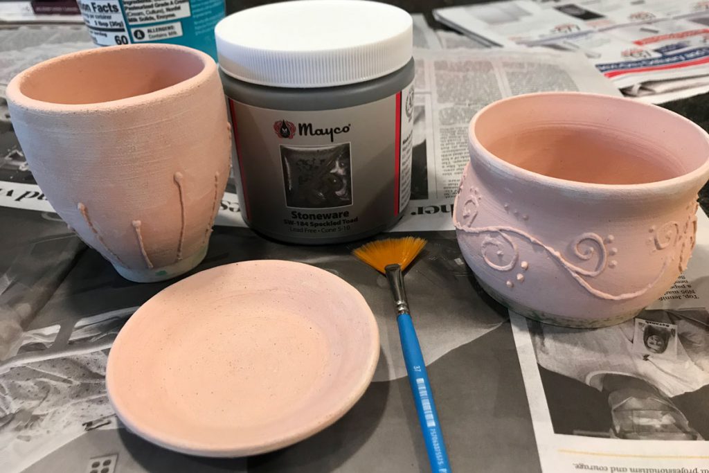 three small wheel thrown pottery pieces before being glazed
