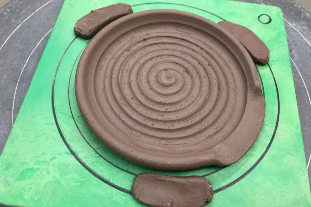 wheel thrown spoon rest showing additional carving on the inside