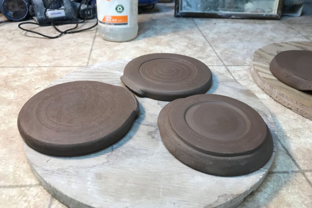 The underside of three hand thrown spoon rests