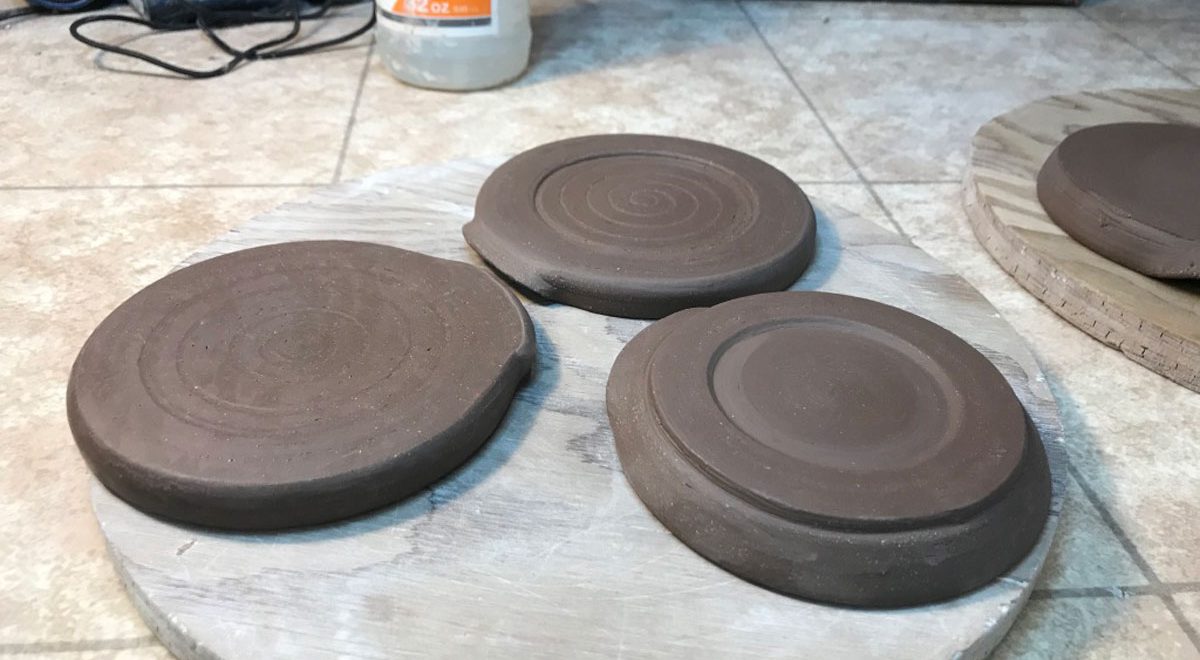 The underside of three hand thrown spoon rests