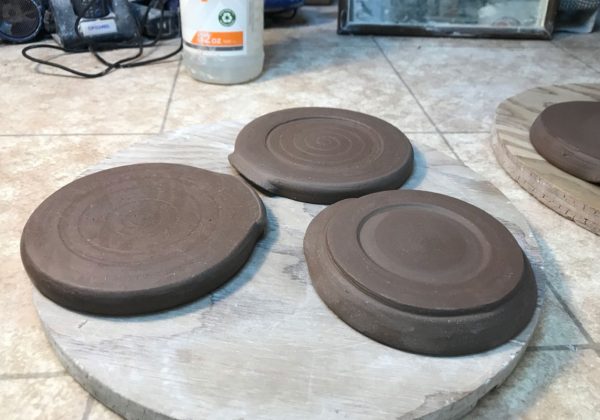 The underside of three hand thrown spoon rests